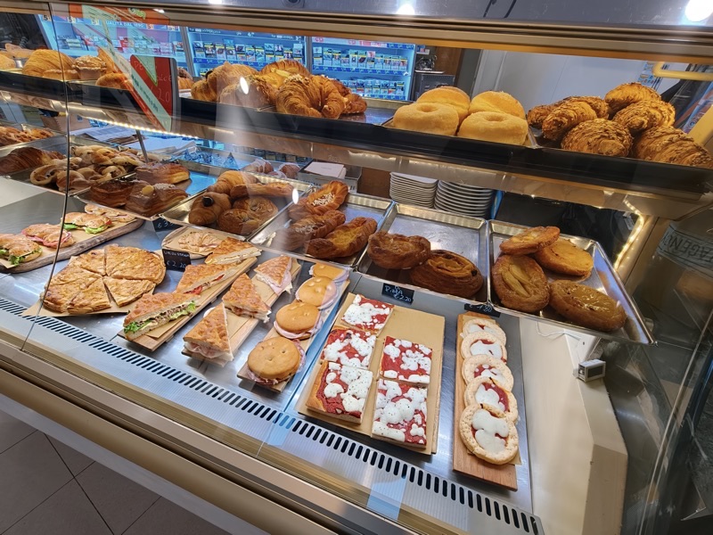 La vetrina della pasticceria di Caffellatte con cornetti, focacce farcite e dolci freschi